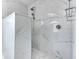 Large walk-in shower with marble tile and rainfall shower head at 1558 Belfry Dr, Venice, FL 34292