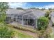 Backyard with screened patio and lush landscaping at 1647 Lancashire Dr # 1647, Venice, FL 34293