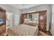 Spacious bedroom with built-in wooden cabinets and a large bed at 1647 Lancashire Dr # 1647, Venice, FL 34293