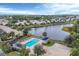 Relaxing community pool with surrounding patio furniture and landscaping at 1647 Lancashire Dr # 1647, Venice, FL 34293