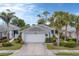 Single-story home with a two-car garage and well-manicured landscaping at 1647 Lancashire Dr # 1647, Venice, FL 34293
