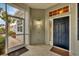 Front entry with a screened porch and dark blue door at 1647 Lancashire Dr # 1647, Venice, FL 34293