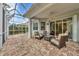 Screened patio with brick pavers and wicker furniture at 1647 Lancashire Dr # 1647, Venice, FL 34293