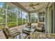 Relaxing screened porch with patio furniture and a view of nature at 1647 Lancashire Dr # 1647, Venice, FL 34293