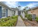 Sidewalk leading to the home's entrance with landscaping at 1647 Lancashire Dr # 1647, Venice, FL 34293