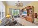 Bright sunroom featuring a large TV and built-in shelving at 1647 Lancashire Dr # 1647, Venice, FL 34293