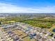 Aerial view of community, showcasing homes, landscape, and a pool at 16766 Carlton Pond St, Wimauma, FL 33598