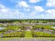 Aerial view of community with pool, playground, and homes at 16766 Carlton Pond St, Wimauma, FL 33598
