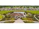 Community clubhouse and pool, surrounded by homes at 16766 Carlton Pond St, Wimauma, FL 33598