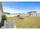Spacious backyard with raised garden beds, patio, and AC unit at 16766 Carlton Pond St, Wimauma, FL 33598