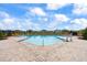 Community pool with lounge chairs and brick pavers at 16766 Carlton Pond St, Wimauma, FL 33598