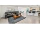 Spacious living area with a leather couch and large windows at 16766 Carlton Pond St, Wimauma, FL 33598