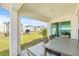 Covered patio with outdoor dining set and backyard view at 16766 Carlton Pond St, Wimauma, FL 33598