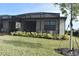 Screened patio with lush landscaping, ideal for outdoor relaxation at 2009 Mackerel St, Port Charlotte, FL 33953