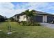 Single-story home with attached garage and landscaped front yard at 2009 Mackerel St, Port Charlotte, FL 33953