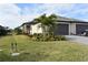 Two-car garage with attractive landscaping and curb appeal at 2009 Mackerel St, Port Charlotte, FL 33953