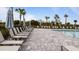 Relaxing pool deck with numerous lounge chairs and umbrellas at 2009 Mackerel St, Port Charlotte, FL 33953