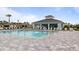 Community pool with a large patio, lounge chairs, and a shaded seating area at 2009 Mackerel St, Port Charlotte, FL 33953