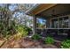 Screened patio and lush backyard with tropical plants and trees at 201 Auburn Woods Cir, Venice, FL 34292