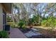 Landscaped backyard oasis with a stone bench, offering a tranquil retreat at 201 Auburn Woods Cir, Venice, FL 34292