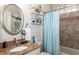 Charming bathroom with granite countertop and light blue shower curtain at 201 Auburn Woods Cir, Venice, FL 34292