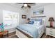 Bedroom with white wooden bed frame and blue bedding at 201 Auburn Woods Cir, Venice, FL 34292