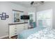 Main bedroom with white dresser and large TV at 201 Auburn Woods Cir, Venice, FL 34292