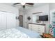Main bedroom with white dresser and large TV at 201 Auburn Woods Cir, Venice, FL 34292
