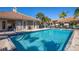 Community pool with adjacent restrooms and seating at 201 Auburn Woods Cir, Venice, FL 34292