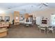 Community room with tables, chairs, and a small kitchen at 201 Auburn Woods Cir, Venice, FL 34292
