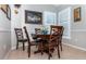Charming dining area with wood table and chairs at 201 Auburn Woods Cir, Venice, FL 34292