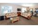 Community fitness center with cardio equipment and sofas at 201 Auburn Woods Cir, Venice, FL 34292