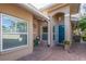 Home's front entry with teal door, brick pavers, and potted plants at 201 Auburn Woods Cir, Venice, FL 34292