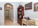 Bright home office features built-in shelving and wood desk at 201 Auburn Woods Cir, Venice, FL 34292