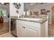 Kitchen with stainless steel dishwasher and granite countertops at 201 Auburn Woods Cir, Venice, FL 34292