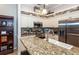 Kitchen boasts granite countertops and stainless steel appliances at 201 Auburn Woods Cir, Venice, FL 34292