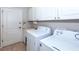 Laundry room with washer, dryer, and cabinets at 201 Auburn Woods Cir, Venice, FL 34292