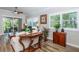 Living room boasts hardwood floors, plantation shutters, and comfy seating at 201 Auburn Woods Cir, Venice, FL 34292