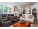 Living room with hardwood floors, leather recliner, and a sofa at 201 Auburn Woods Cir, Venice, FL 34292
