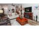 Living room with hardwood floors, comfortable seating, and view to kitchen at 201 Auburn Woods Cir, Venice, FL 34292