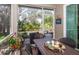 Relaxing screened patio with table and chairs, overlooking a lush, natural landscape at 201 Auburn Woods Cir, Venice, FL 34292