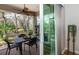 Enjoy the screened-in porch with table and chairs at 201 Auburn Woods Cir, Venice, FL 34292