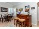 Elegant wet bar with wood cabinetry and seating at 201 Auburn Woods Cir, Venice, FL 34292