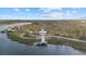 Aerial view of community lake with observation tower and walking paths at 20450 Passagio Dr, Venice, FL 34293