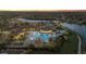 Community pool and clubhouse at night with lights illuminating the area at 20450 Passagio Dr, Venice, FL 34293