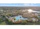 Resort-style community pool, tennis courts, and clubhouse with expansive lake views at 20450 Passagio Dr, Venice, FL 34293