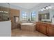 Spa-like bathroom with a large walk-in shower and soaking tub at 20450 Passagio Dr, Venice, FL 34293