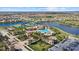 Aerial view of community pool, tennis courts, and clubhouse at 20450 Passagio Dr, Venice, FL 34293