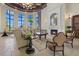Elegant clubhouse with a fireplace and large windows overlooking the pool at 20450 Passagio Dr, Venice, FL 34293