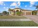 Spacious home with a three-car garage and manicured lawn at 20450 Passagio Dr, Venice, FL 34293